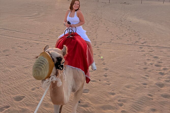 Abu Dhabi Desert Safari with Live Entertainment and Live BBQ - Camel riding and sandboarding at camp
