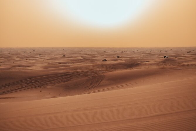 Deluxe Sunset Desert Safari: SandSurfing, Camel Ride & BBQ dinner - Leaving Dubai behind in a six-seat 4x4