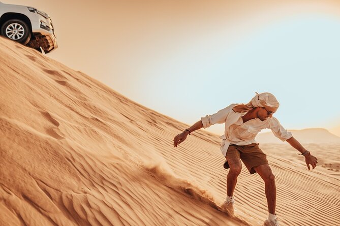 Deluxe Sunset Desert Safari: SandSurfing, Camel Ride & BBQ dinner - Red Dunes dune bashing for 30 minutes