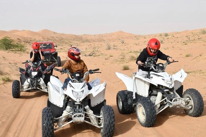 Desert Safari W/BBQ Dinner, Quad Bike, Camel Ride, & Sandboarding - Quad biking and sandboarding on the dunes