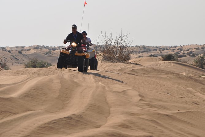 Dubai Desert Afternoon Quad Safari with Camel Ride, BBQ Dinner and Belly Dancing - Entering the torchlit desert camp