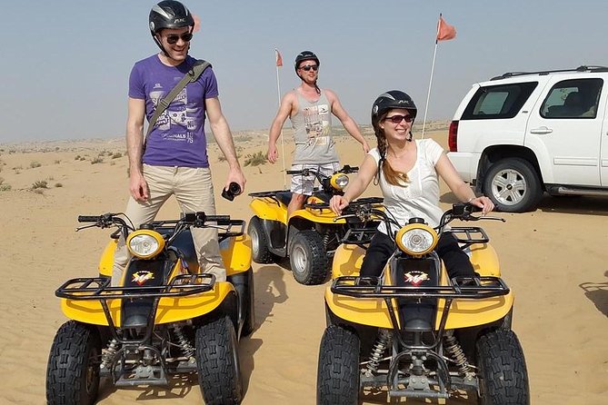 Dubai Desert Afternoon Quad Safari with Camel Ride, BBQ Dinner and Belly Dancing - Taking control of the quad bike