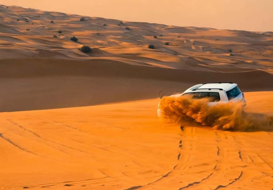 Dubai: Desert Safari, Camel Ride, Sandboard & Buffet Dinner - Leaving Dubai for the Open Desert
