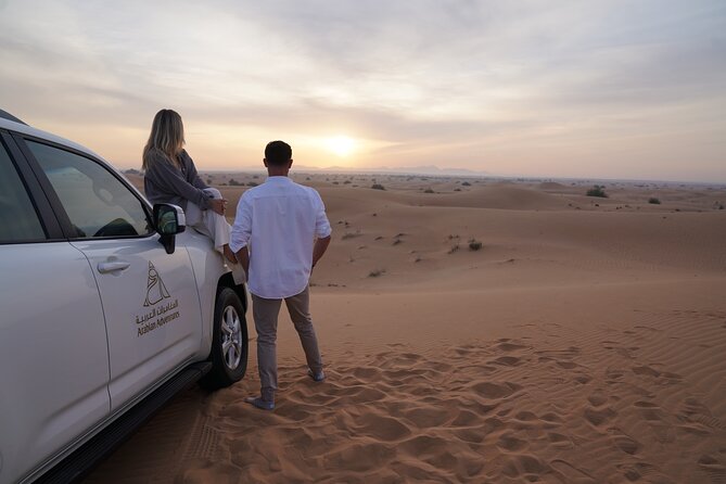 Dubai Desert Safari: Camel Ride, Sandboarding, BBQ & House Drinks - Camel riding and sandboarding in small doses