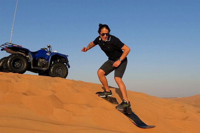 Dubai: Desert Safari, Camel Ride, Show & Optional Dinner - Sandboarding on a steep red dune