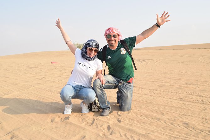 Dubai Desert Safari with BBQ, 3 Shows & Camel Ride at Majlis Camp - Sandboarding, henna, shisha, and Arabic clothing