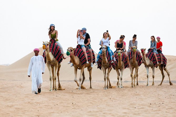 Dubai Desert Safari with Quads, BBQ Dinner, Camel ride, & Shows - Dune bashing across the sunset sands