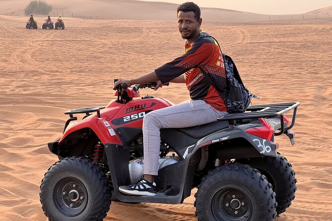 Dubai Evening Red Dune Safari With 30 Mins ATV, BBQ, Live Shows - Camel riding, sandboarding, and sunset