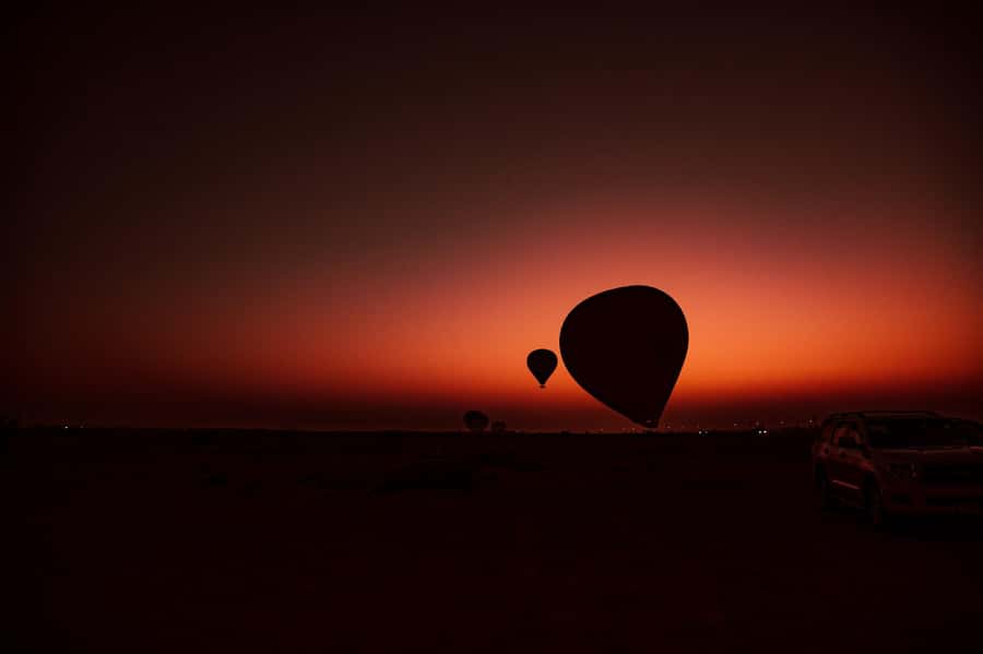Dubai: Hot Air Balloon Ride with Camel Ride & Falcon Show - Sunrise above the red dunes at 4,000 feet