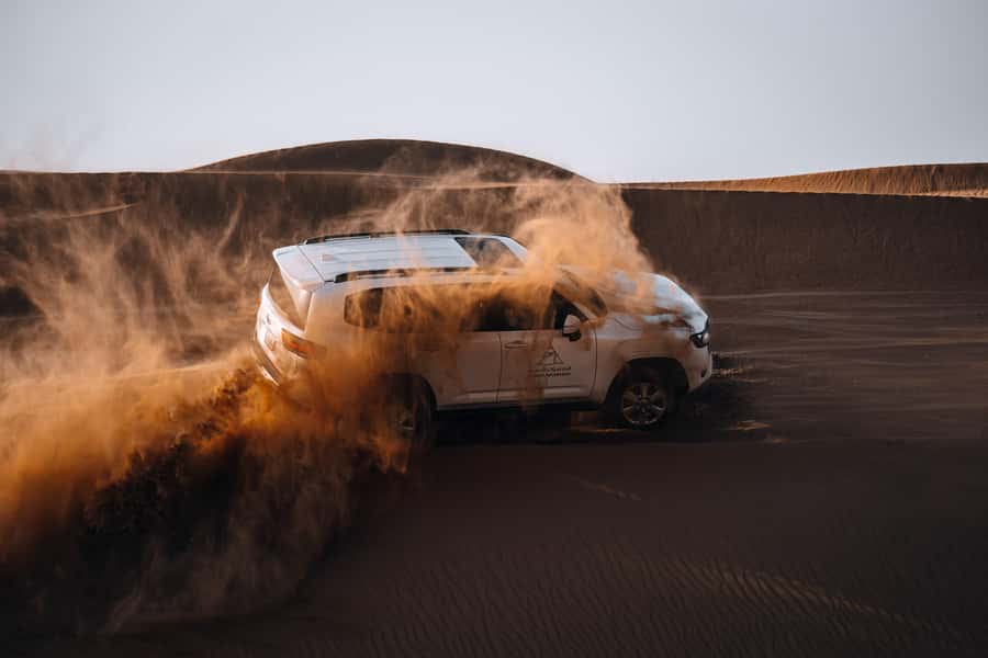 Dubai: Premium Desert Safari, Camel Ride, BBQ & Sandboarding - Leaving Dubai in a Four-Wheel Drive