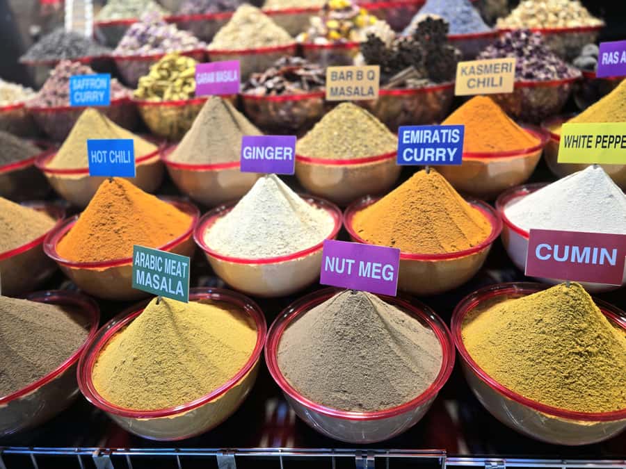 Dubai: Premium Old Town, Street Food, Souks & Boat Ride Tour - Smelling the spices at Dubai Spice Souk