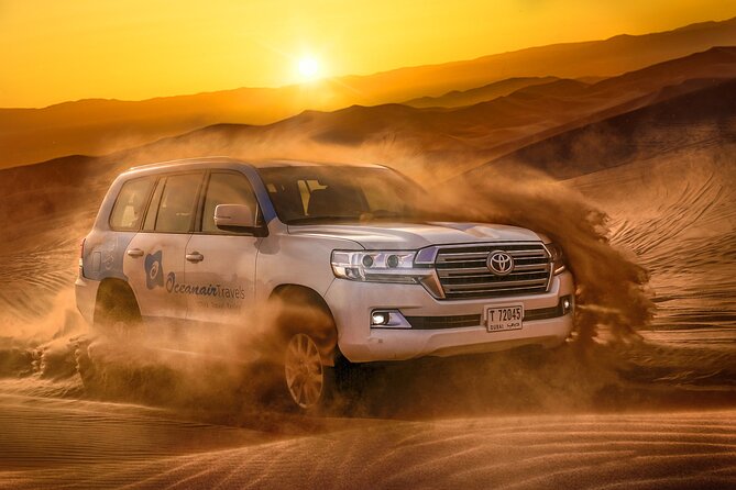 Dubai Premium Red Dunes Safari, Camels & 5<em> BBQ at Al Khayma camp – Key points to know before booking’ /></p>
<ul>
<li><strong>Red dunes make the first half memorable:</strong> Lahbab’s tall orange dunes provide the best setting for dune driving, sandboarding, and sunset photos.</li>
<li><strong>The $75 price covers a lot:</strong> Pickup, a 4WD ride, dune bashing, sandboards, camel rides, camp activities, buffet dinner, drinks, and evening entertainment are included.</li>
<li><strong>Your guide matters:</strong> Guides such as Rashid Mir, Abid Wahid, Sunil, Tofeeq Abbas, Shams, and Sarg have been praised for safe driving, humor, useful information, and helping with photographs.</li>
<li><strong>The ATV is extra:</strong> Quad biking is available only with selected options or on request, and it costs more than the advertised tour price.</li>
<li><strong>Evening timing changes the program:</strong> The 11:30 AM departure includes lunch but not the fire show or stargazing. Choose an evening departure if those matter to you.</li>
<li><strong>Expect a real group outing:</strong> Pickup is shared, timing can shift, and the entire day may last about seven hours from hotel to hotel.</li>
</ul>
<h2 id="pickup-from-dubai-and-the-hour-long-ride-to-lahbab">Pickup from Dubai and the hour-long ride to Lahbab</h2>
<p><img width="669" height="446" decoding="async" src=