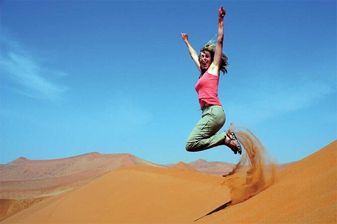 Dubai Red Dune Safari with BBQ Dinner and Live Shows - Sandboarding and sunset photos on the red dunes