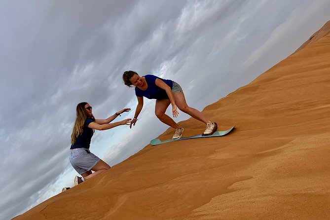 Dubai Red Dunes Quad Bike Tour,Sandboard, Camel ride & BBQ Dinner - From central Dubai to the red dunes of Lahbab