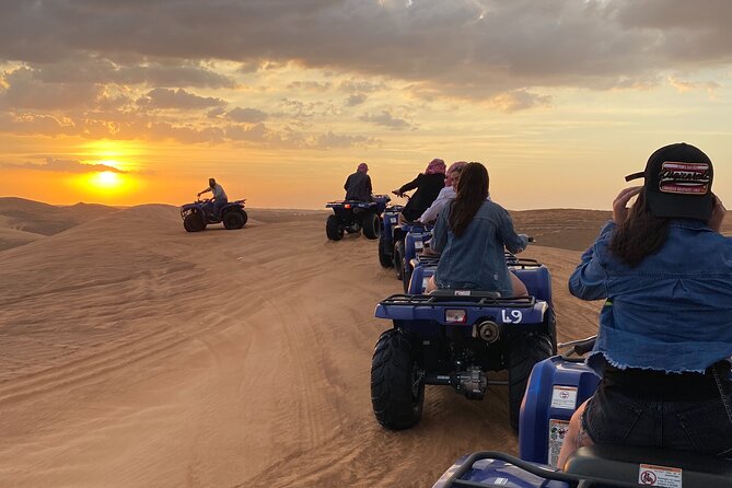 Dubai Red Dunes Quad Bike Tour,Sandboard, Camel ride & BBQ Dinner - Sandboarding and the sunset photo stop