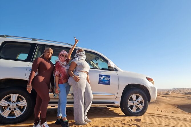 Dubai Red Dunes with Sandboarding, Camel Ride, Falcon & VIP Camp - Sunset, red sand, and a falcon on your shoulder