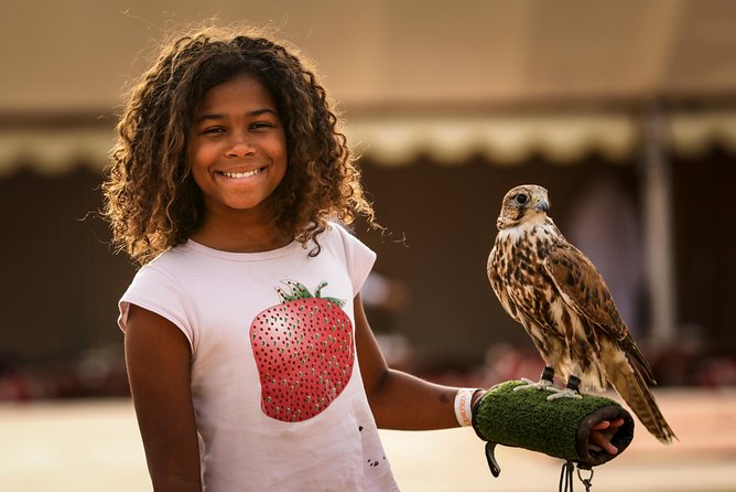 Dubai Sunset Camel Trekking with Shows & BBQ Dinner - Local clothing, falcons, and camel feeding