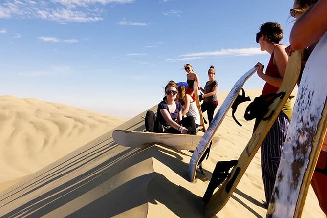 Morning Desert Safari Dubai with Dune Bashing and Sand Boarding - Sandboarding from a tall dune