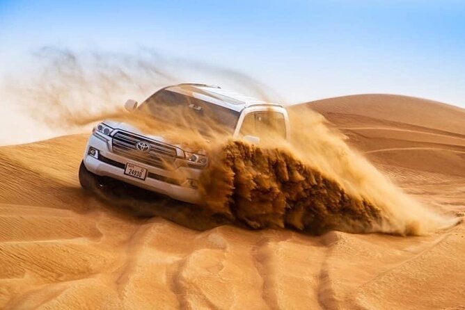 Morning Desert Safari with Sandboarding & Camel Ride on Red Dunes - Sandboarding on soft desert slopes
