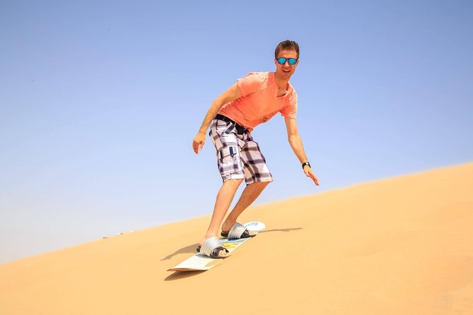 Morning Red Dunes Desert by Quad Bike, Dune Bashing, Camel Ride & Sandboarding - Sandboarding from a high dune
