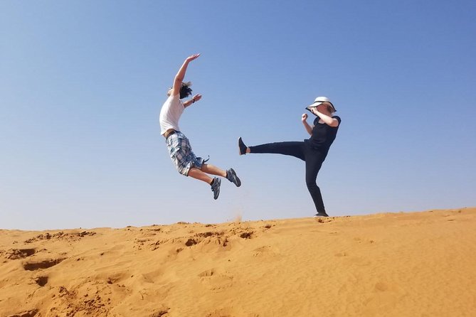 Morning Thrill: Exciting Desert Safari Adventure Camel Ride Dubai - Sandboarding on a Tall Dune