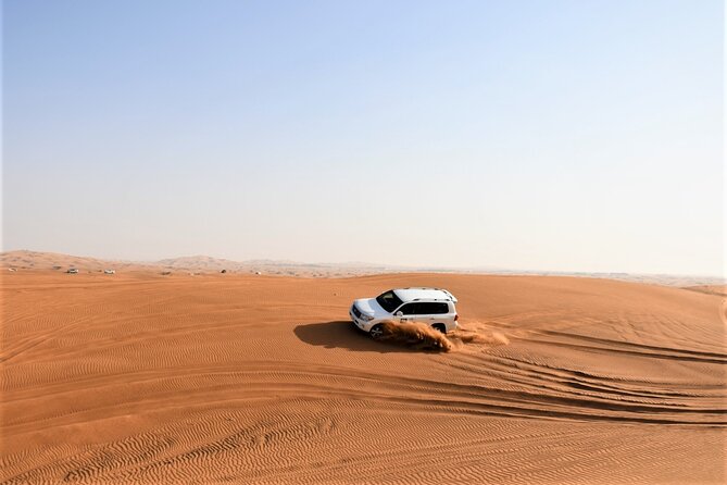 Premium Red Dunes Bashing with Quad Bike, Camel, Falcon &VIP Camp - Quad biking in the red sand
