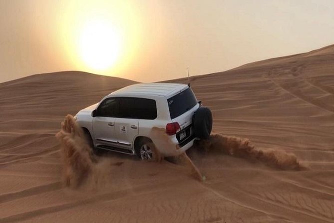Premium Sundowner Red Dunes & Camel Safari with BBQ Dinner - Sandboarding and camel riding at the desert camp