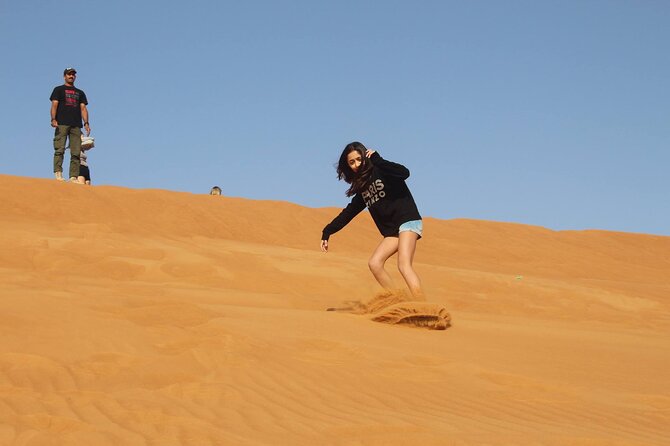 Private 4x4 Sunrise Desert Safari with Refreshments & Camel Ride in Dubai - Sand boarding on the dunes