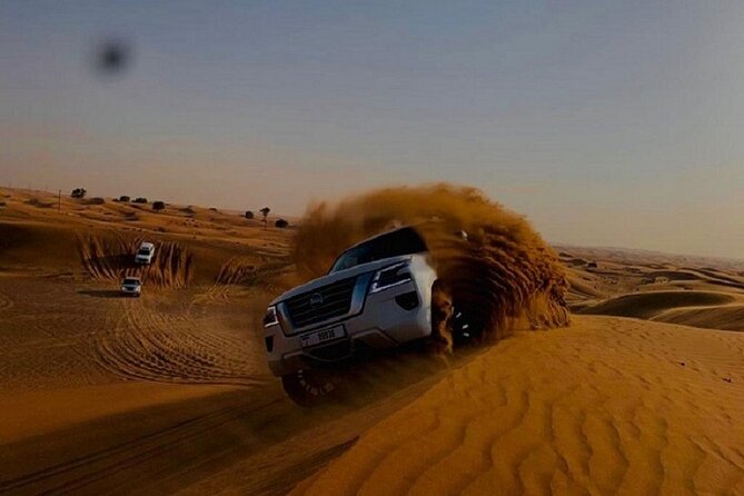 Private Evening Red Sand Desert Safari with BBQ Dinner - A 10-minute camel ride and henna at camp
