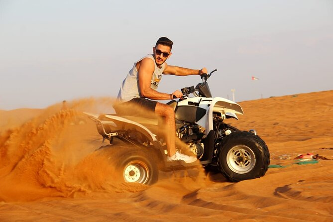 Sunrise Desert safari With Quad bike ride Sandboard & Camel ride - Sandboarding on the red dunes